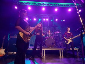 a group of women on a stage with instruments